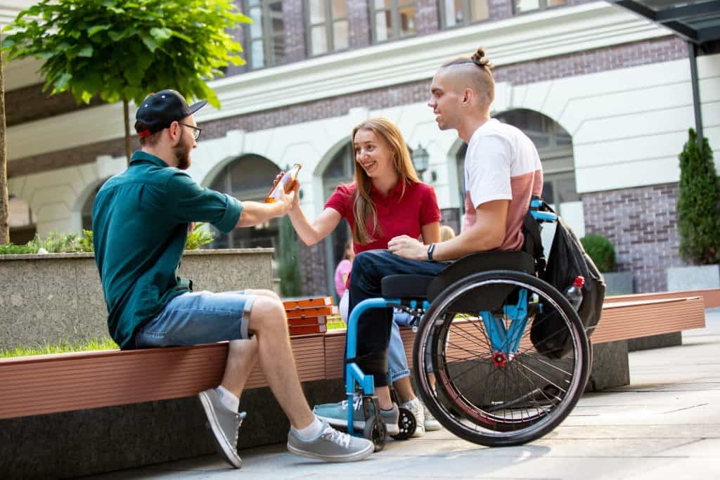 Disabled man with friends on summer day