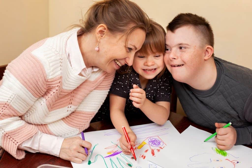 Child painting with down syndrome