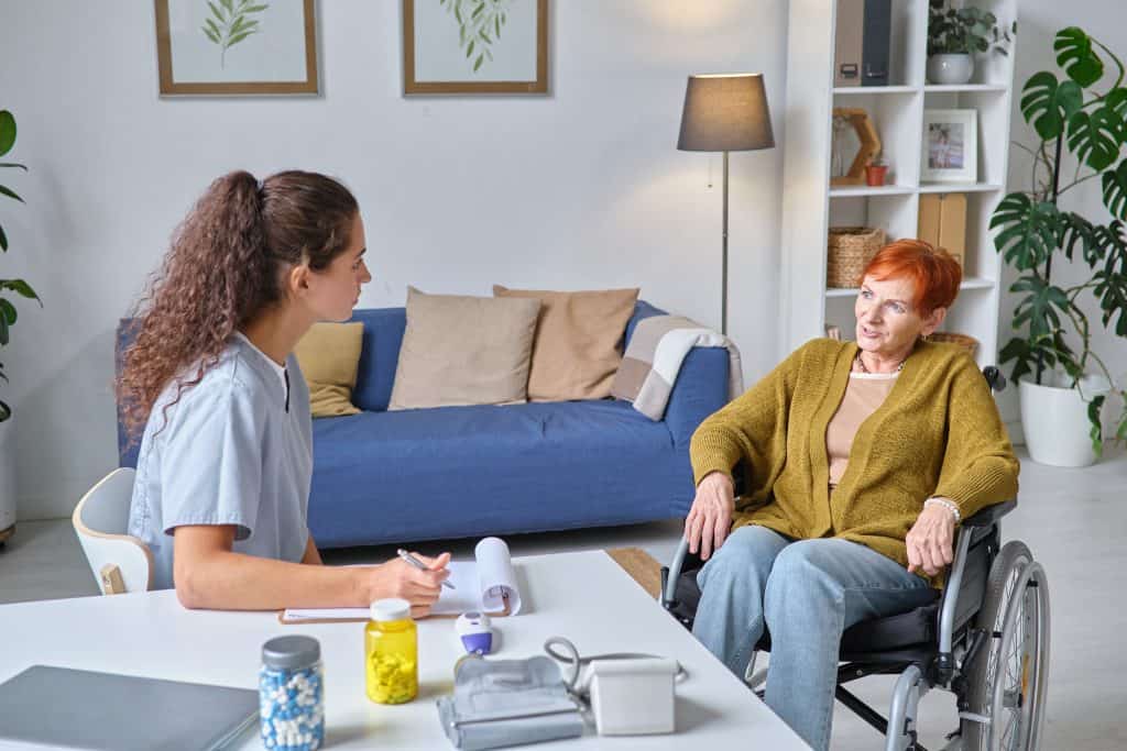 Disabled woman discussing treatment options with carer